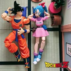 two figurines are posed next to each other