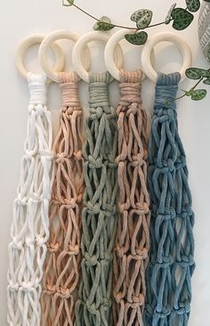 four different colors of rope hanging on a wall