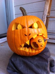 a pumpkin carved to look like a cat with its mouth open and teeth wide open