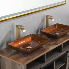 two sinks are shown with gold faucets on them