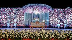 the stage is decorated with flowers and chandeliers