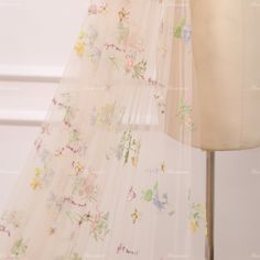 a dress with flowers and butterflies on it