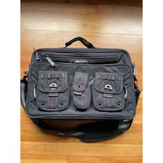 a black bag sitting on top of a wooden floor