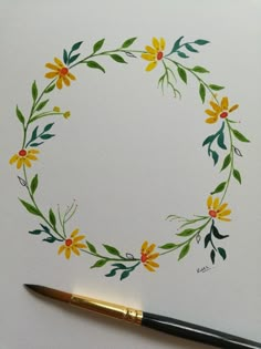 a watercolor painting of yellow flowers and green leaves in a circle on white paper