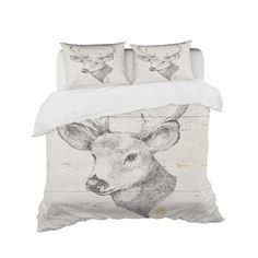 a bed with two pillows on top of it and an image of a deer in the background