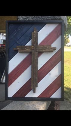 a wooden cross with an american flag painted on it