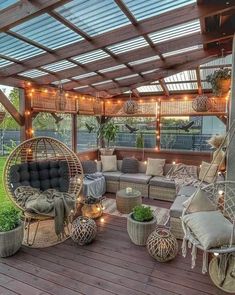 an outdoor living area with wicker furniture and lights