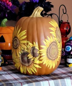 a pumpkin with sunflowers painted on it