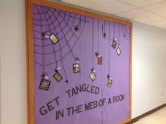 a bulletin board that says get tangled in the web of a book