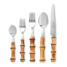 an assortment of utensils with bamboo handles