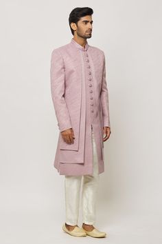 Lilac pink layered sherwani with thread work and statement buttons in art silk base. Paired with a cream aligadi pant. - Aza Fashions Designer Pink Kurta With Naqshi Details, Pink Bandhgala With Zari Work For Eid, Pink Bandhgala With Zari Work And Long Sleeves, Fitted Pink Sherwani With Pallu, Traditional Pink Bandhgala For Designer Wear, Pink Traditional Bandhgala For Designer Wear, Fitted Pink Bandhgala With Zari Work, Pink Long Sleeve Bandhgala With Zari Work, Fitted Pink Sherwani For Reception