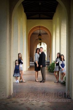 a family poses for a photo in an archway