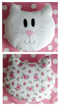 two pillows with cat faces on them, one is white and the other has pink roses