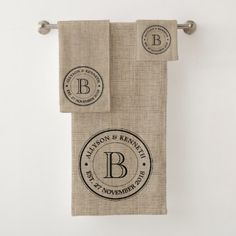 two towels hanging on a towel rack with monogrammed labels and the letter b