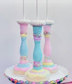 there are three colorful candles on top of each other