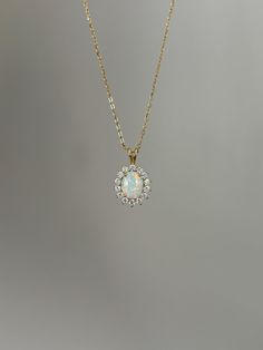 One of my personal favorites, this opal necklace is a must-have! Information: ✨ Simulated Opal Gemstone | High Quality ✨ Sterling Silver (925 stamped) | 14K Gold Plated ✨ AAA Cubic Zirconia diamonds ✨ Adjustable length: 16" - 18" ✨ Hypoallergenic  ✨ Tarnish resistant A classic, this necklace is the perfect addition to you collection - it holds a beautiful sophisticated vibe that upgrades your outfit instantly. Personally, I wear this piece quite often and the sparkles are so strong that I am alw Formal Opal Necklace With 17 Jewels, Elegant Ethiopian Opal Pendant Necklace, Dainty Opal Pendant Necklace, Delicate Opal Gemstone Necklaces, Oval Opal Necklace For Anniversary, Yellow Gold Opal Necklace For Anniversary, Opal Round Pendant Necklace For Anniversary, Oval Opal Necklace For Wedding, Anniversary Opal Round Pendant Necklace