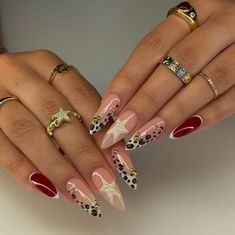 Alternate nails with a cheetah, star, and red nail art. Nails Inspiration Leopard Print, Vegas Nails Ideas Sparkle Almond, Exotic French Tip Nails, Animal French Tip Nails, Stiletto Leopard Nails, Nail Art Designs Leopard, Animal Print Nail Art Leopards, Kalogeras Sisters Nails, Glamour Nails Designs