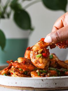 a person dipping some food into a bowl