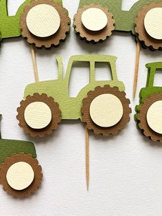 green tractor cupcake toppers on sticks with brown and white paper circles in the shape of tractors