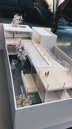 a model of a building with people walking around it