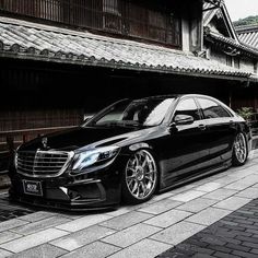 a black car parked in front of a building