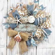 a wreath that says find paradise, where you can go with the starfish and seashells