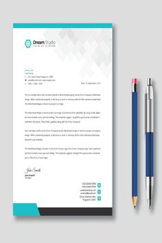 a letterhead and pen on top of a paper with the words dream studio written in it