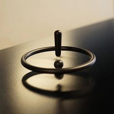 a black ring sitting on top of a table