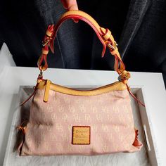 Dooney & Bourke Pink Canvas Leather East/West Slouch Monogram Shoulder Bag Pink And Cream Canvas Exterior Gorgeous Light Tan Leather Trim Classic Pink And White Interior Canvas Adjustable Strap, Zip Closure One Inside Zip Pocket, Small Multi Function Pocket. Inside Key Hook Condition: New Without Tags, Excellent Condition. (See Photos) Dimensions: Length At Bottom: 13"L X 7.5"H X 4.5"W Shoulder Drop: 9" Pink And White Interior, Pink Monogram Canvas Shoulder Bag For Daily Use, Pink Monogram Canvas Rectangular Shoulder Bag, Pink Rectangular Monogram Canvas Shoulder Bag, Pink Dooney And Bourke Handbags, Pink Leather Shoulder Bag With Gold-tone Hardware, Dooney And Bourke Handbags Dooney & Bourke, Dooney & Bourke Bags Dooney & Bourke, Shoulder Bag Pink