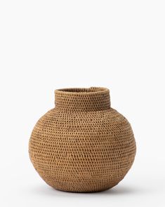 a brown vase sitting on top of a white surface