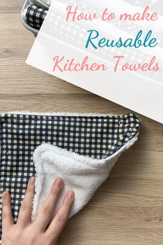 someone wiping up the kitchen towels on top of a wooden table with text overlay that reads how to make reusable kitchen towels