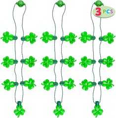 green shamrocks are hanging from strings on a white background with the words 3 pics above them