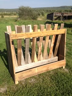 a wooden bench sitting on top of a lush green field