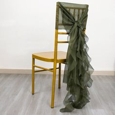 a chair with a green ruffle on it next to a yellow chair in a room