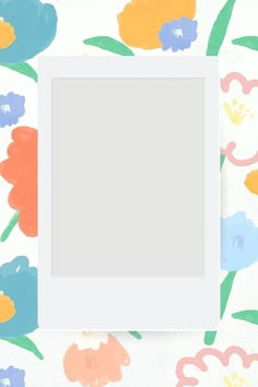 an empty photo frame sitting on top of a flowered wallpaper with colorful flowers