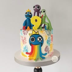 there is a colorful cake with monsters on it