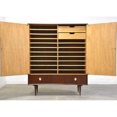 a large wooden cabinet with two drawers on one side and an open drawer on the other