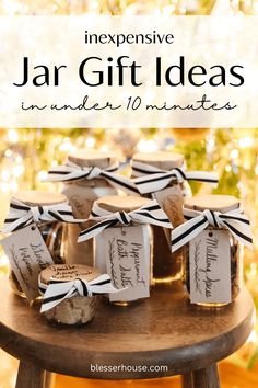 jars filled with jam sitting on top of a wooden table in front of a christmas tree