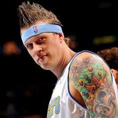 a man with tattoos on his arm and headband