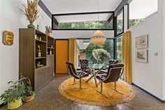 a living room filled with furniture and a yellow rug