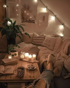 a living room filled with lots of furniture and candles on top of the coffee table