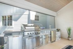 an outdoor kitchen with stainless steel appliances