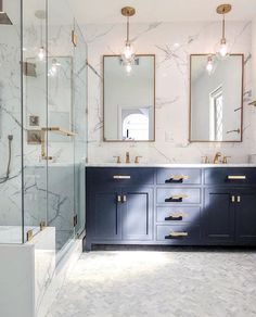 a bathroom with two sinks, mirrors and marble counter tops on the walls is shown