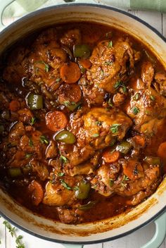 a pot filled with meat and vegetables on top of a table