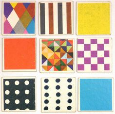 a group of different colored squares and dots on a white surface with black dots in the middle