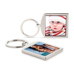 a square metal keychain with a photo on it