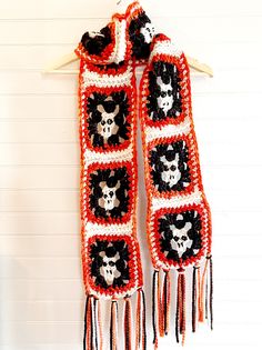 a crocheted scarf with skulls and bones on it