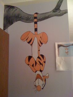 a drawing of tigger hanging from a tree branch on the wall in a child's bedroom