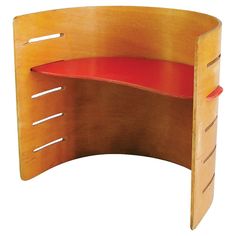 a curved wooden desk with a red seat on the top and bottom shelf for storage