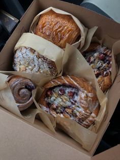 four pastries are in a box on the table